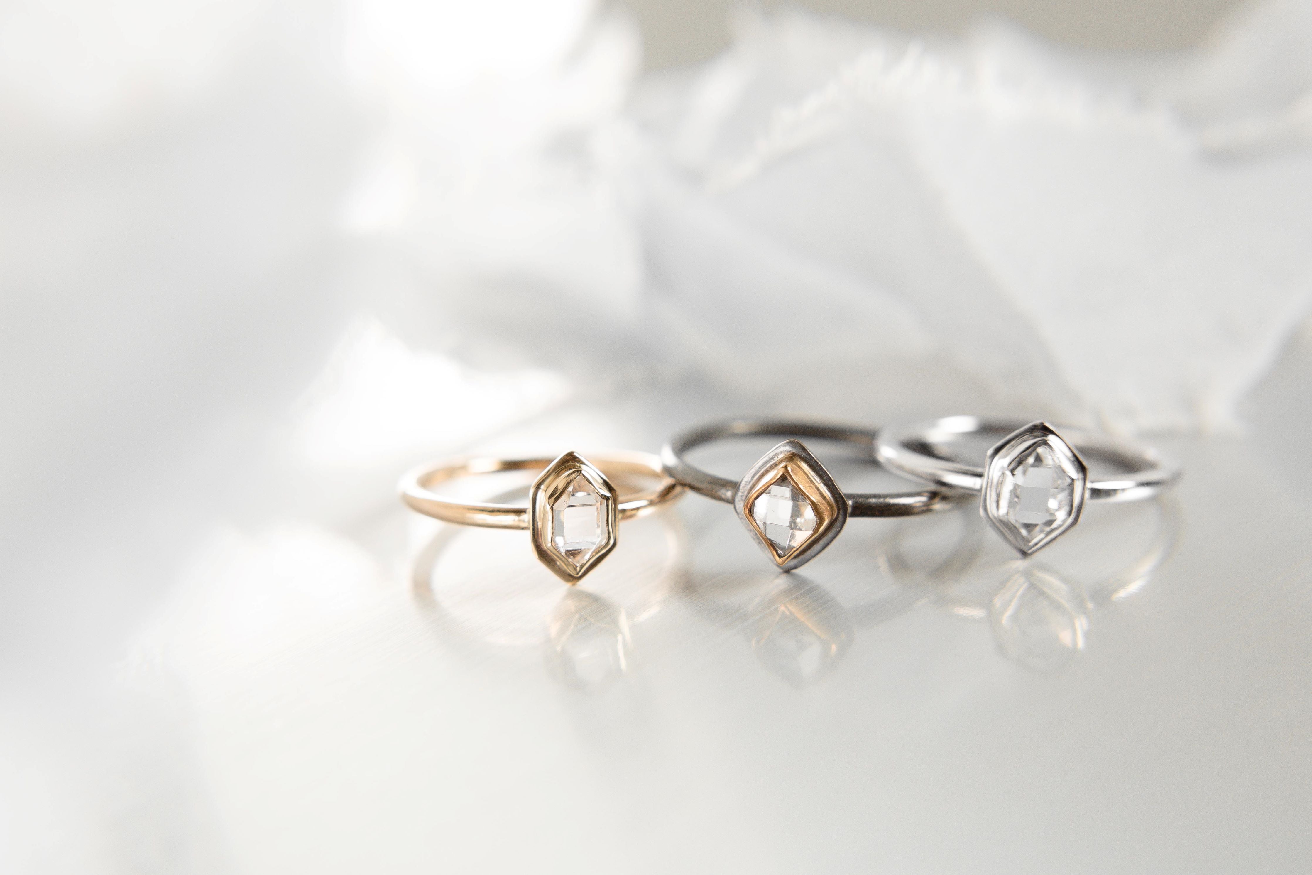 a collection of 3 rings featuring herkimer diamond in sterling silver and 14k gold.