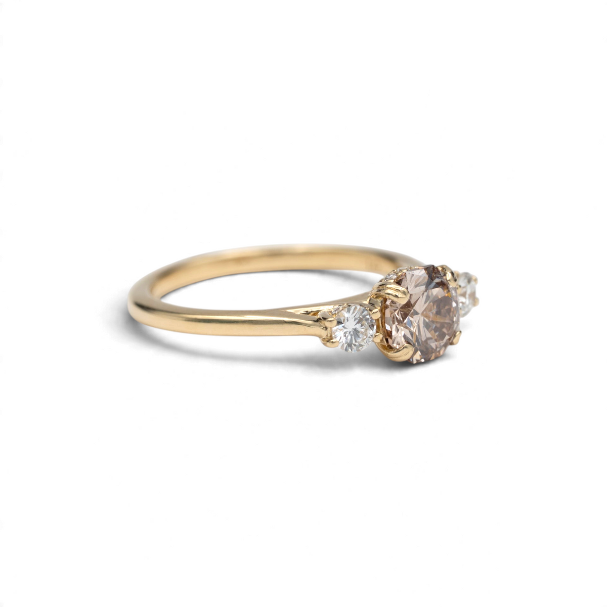 Stórica Studio Laurel three stone ring with a champagne octagon lab-grown diamond and hidden diamond halos in 14k yellow gold