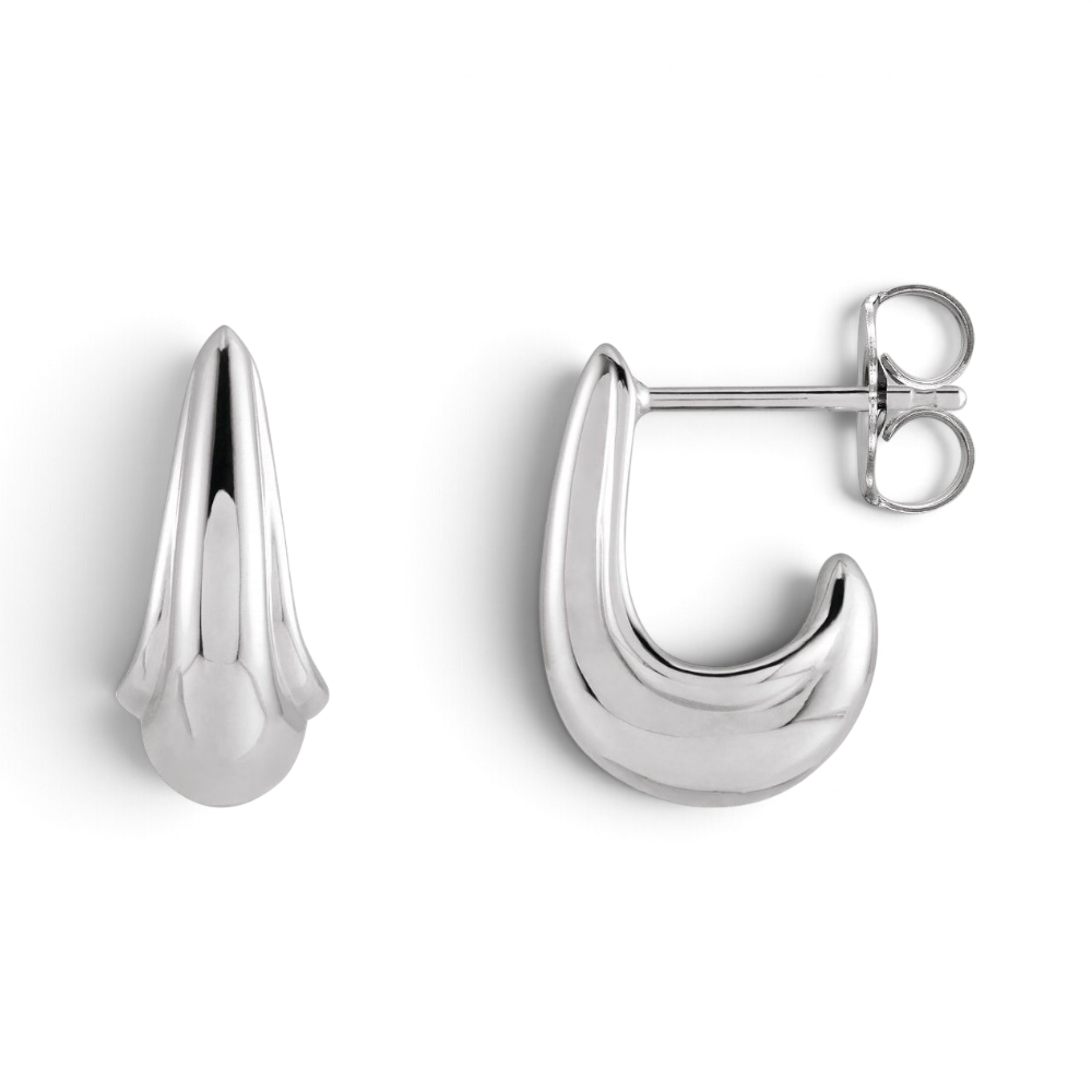 Stórica Studio Swell sterling silver tapered J-hoop earrings with a polished sculptural wave-inspired design.