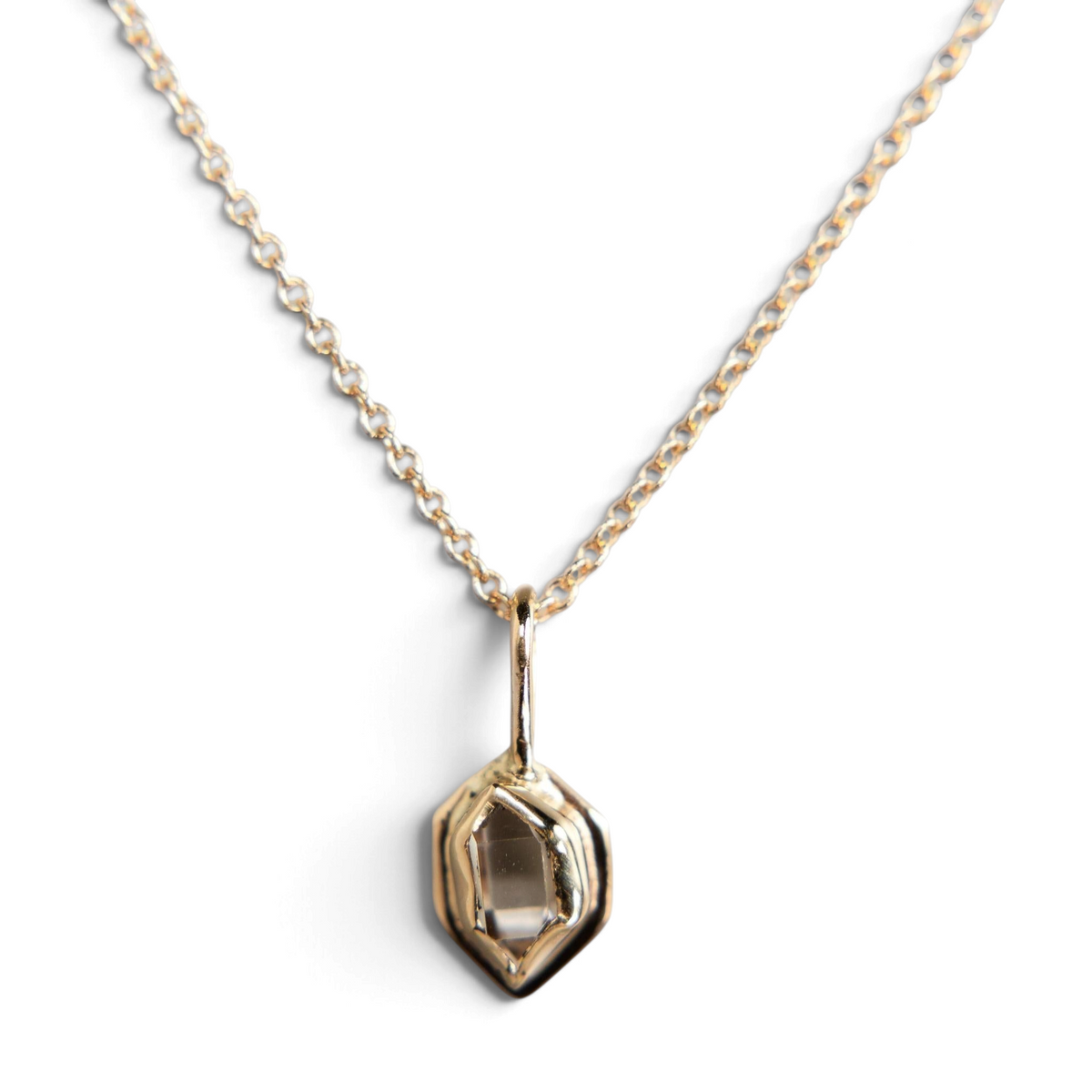 Stórica Studio Glacier Charm featuring a raw Herkimer diamond crystal in a gold recycled metal bezel on a chain