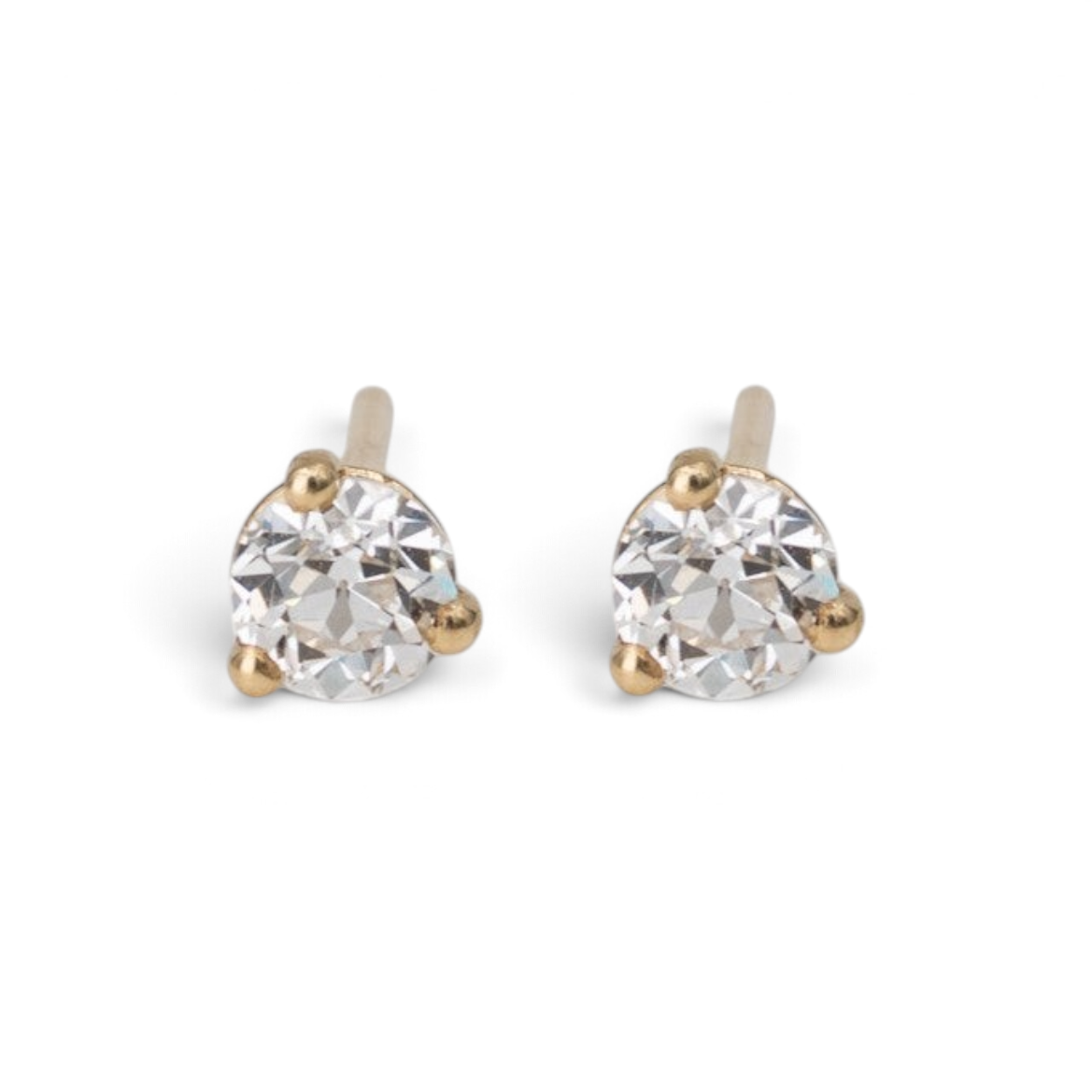 Stórica Studio Spark diamond stud earrings featuring old mine cut diamonds in 14k yellow gold three-prong settings.