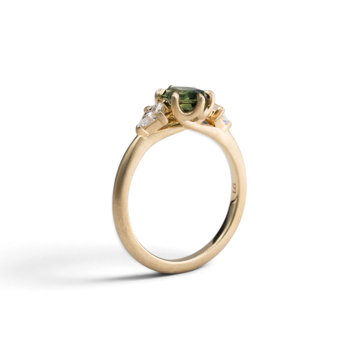 Stórica Studio 14k yellow gold ring with a 1.05ct elongated hexagon green sapphire and kite-shaped diamond accents.