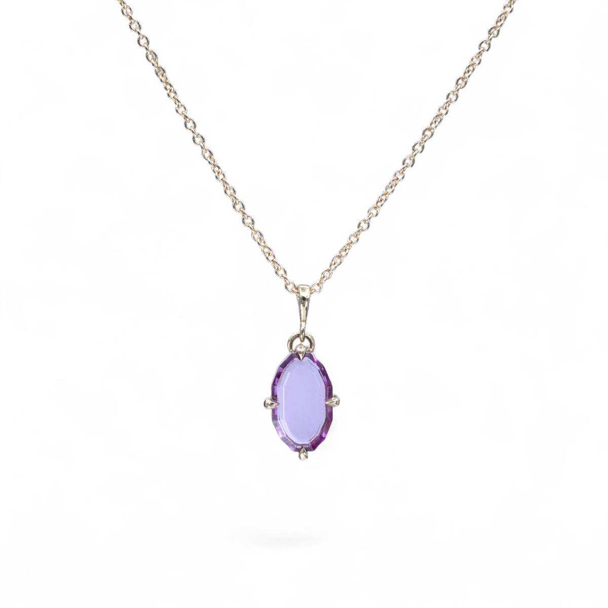 Rosewater pink portrait-cut sapphire necklace in 14k yellow gold with four claw prongs and bail on a cable chain
