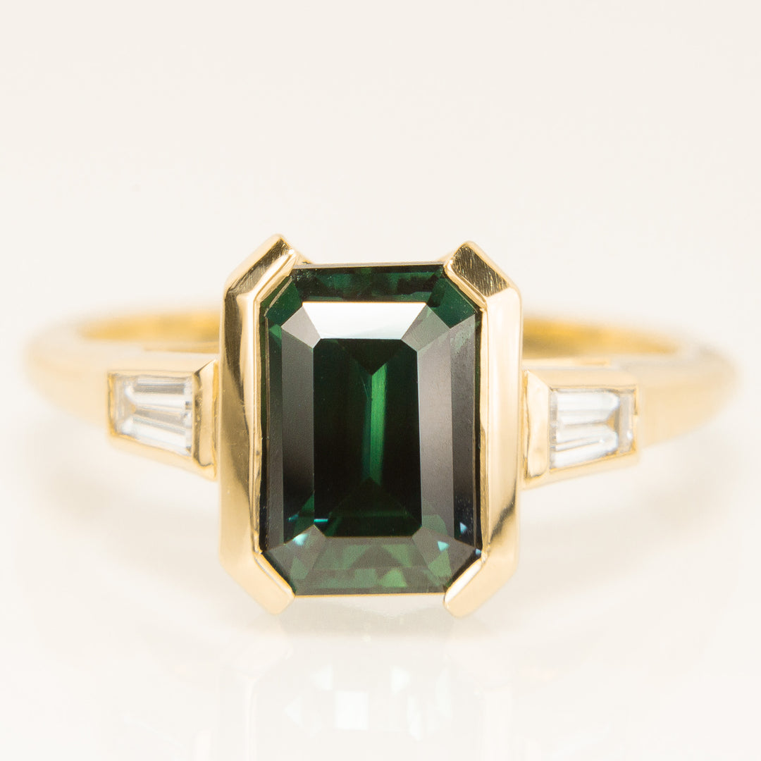 Emerald Cut Teal Sapphire Trilogy Ring in 18k Yellow Gold