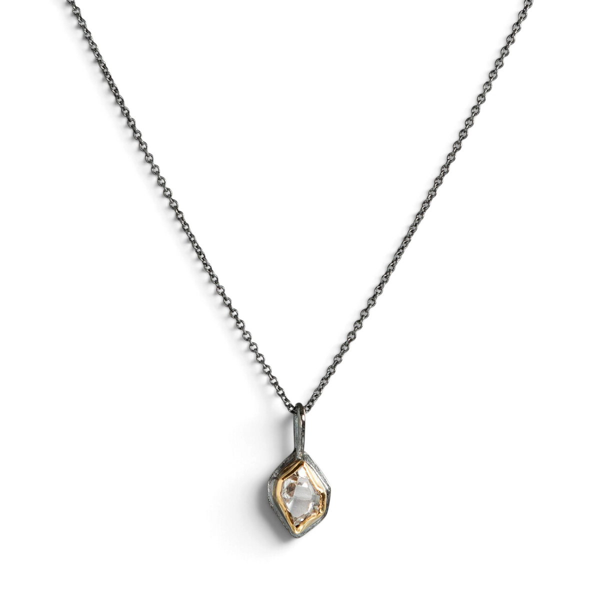 Stórica Studio Glacier Charm featuring a raw Herkimer diamond in a gold and oxidized sterling silver bezel on a chain