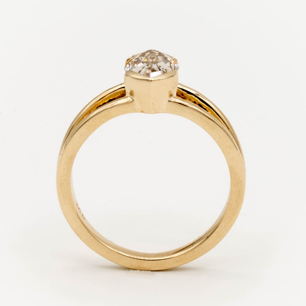 1.5ct Canadian-mined champagne diamond in a geometric marquise cut, set in a half-bezel Willow style double band, crafted in 14k yellow gold. Ethically sourced custom engagement ring from Seattle, WA.