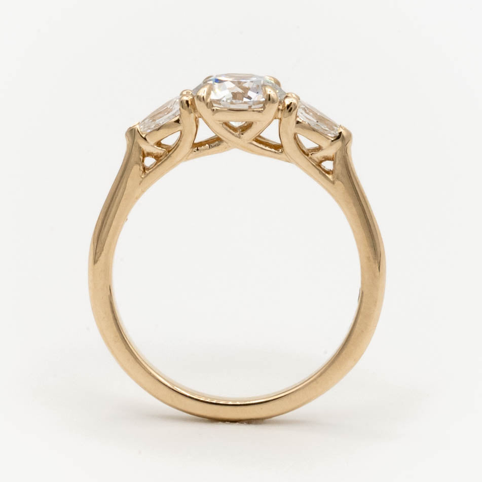 Storica’s classic 3-stone engagement ring featuring a 1 carat D color, VVS2 clarity lab-grown diamond center and pear-shaped lab-grown diamonds in a trellis setting, crafted in 14k yellow gold.