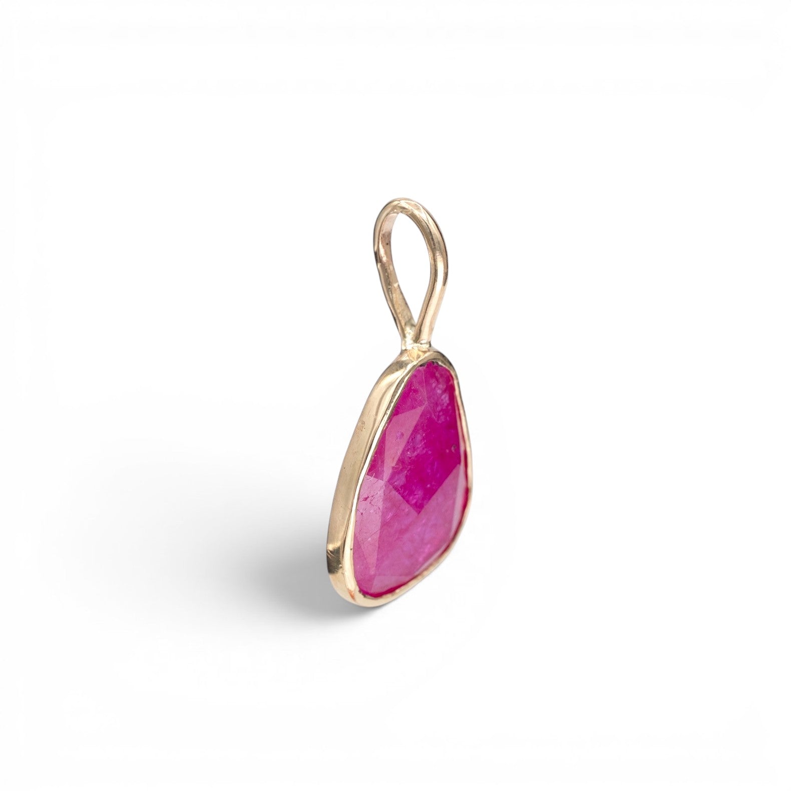 Stórica Studio Persephone charm featuring a freeform rose-cut ruby in a 14K yellow gold bezel setting.