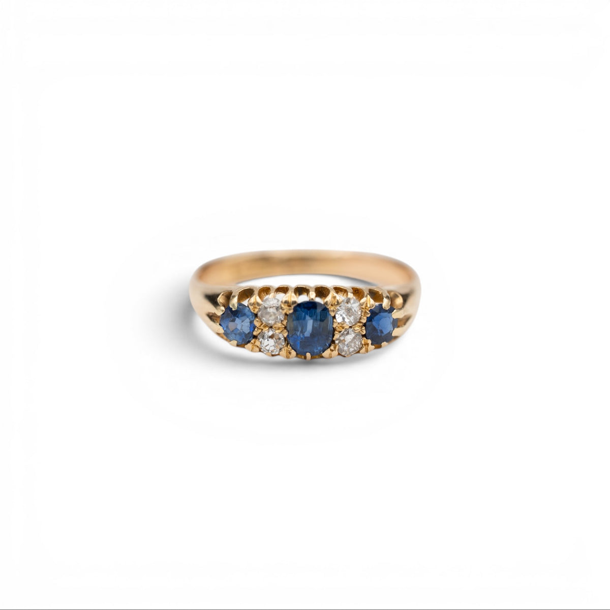 Stórica Studio Bluebell Victorian seven stone ring with three blue sapphires and four antique diamonds in 18k yellow gold