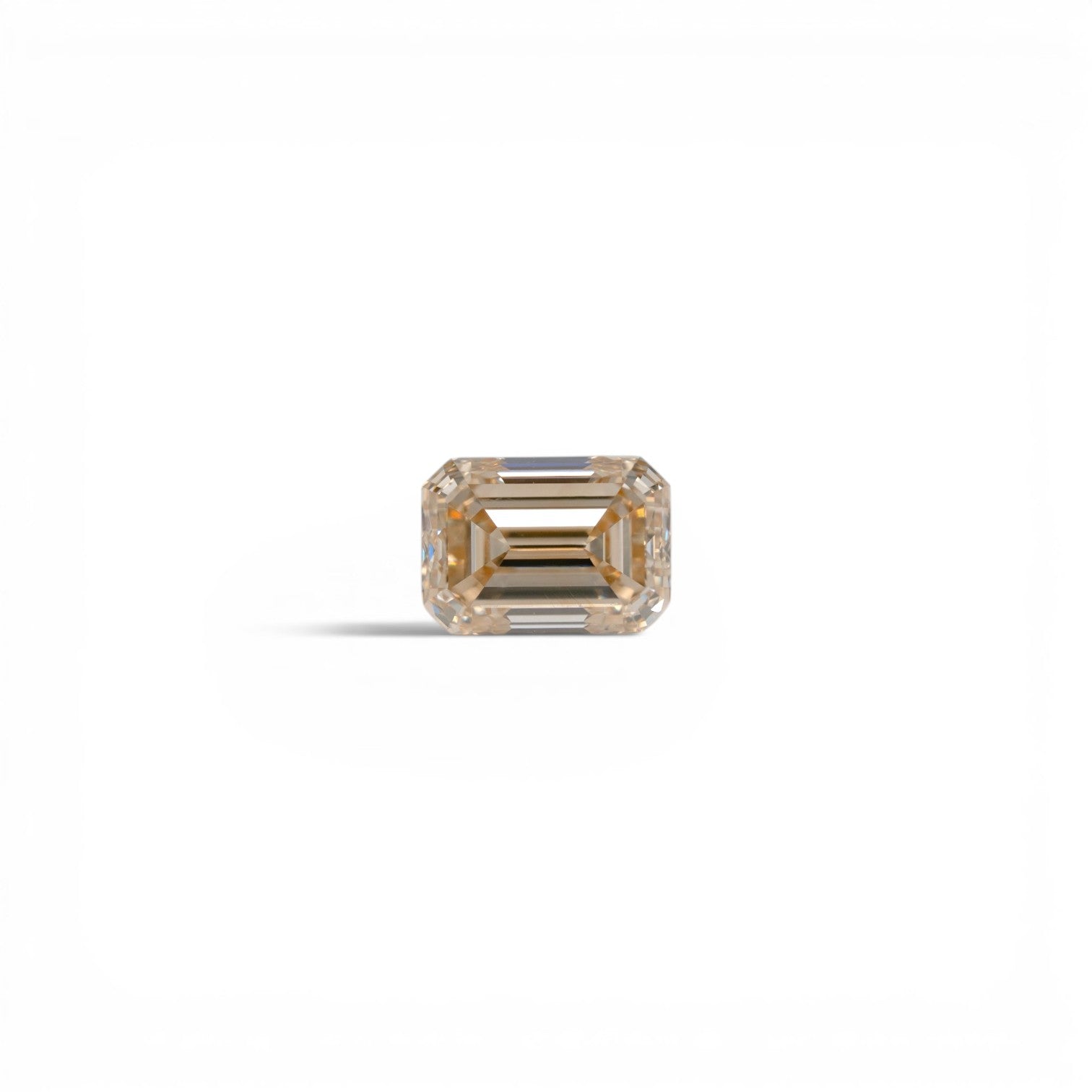 Stórica Studio 1.11ct emerald cut champagne diamond, C4 color, VS1 clarity, with elegant step faceting.