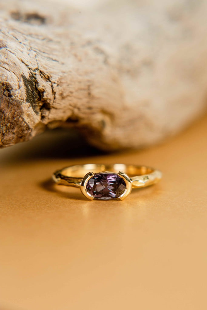 A sterling silver ring featuring 2 purple amethyst gemstones.
