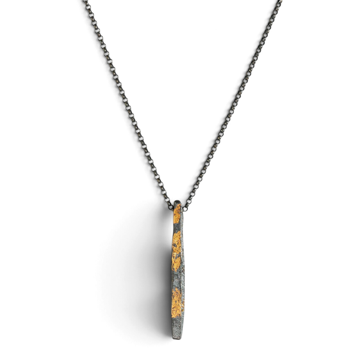 Stórica Studio Gilded Relic bar necklace featuring oxidized silver and 24k gold foil on an 18-inch rolo chain.