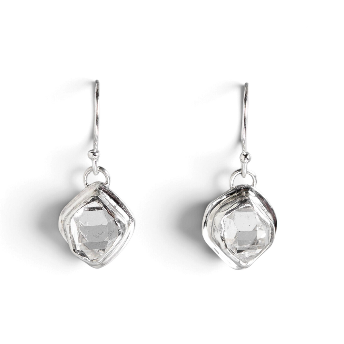 Stórica Studio Glacier drop earrings featuring raw Herkimer quartz crystals in minimal sterling silver bezel settings.