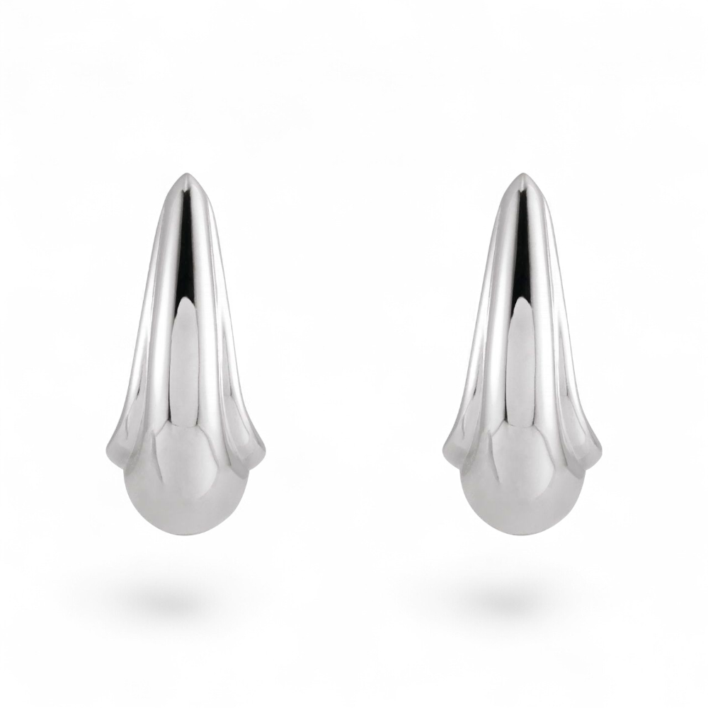 Stórica Studio Swell sterling silver tapered J-hoop earrings with a sculptural, modern polished finish.