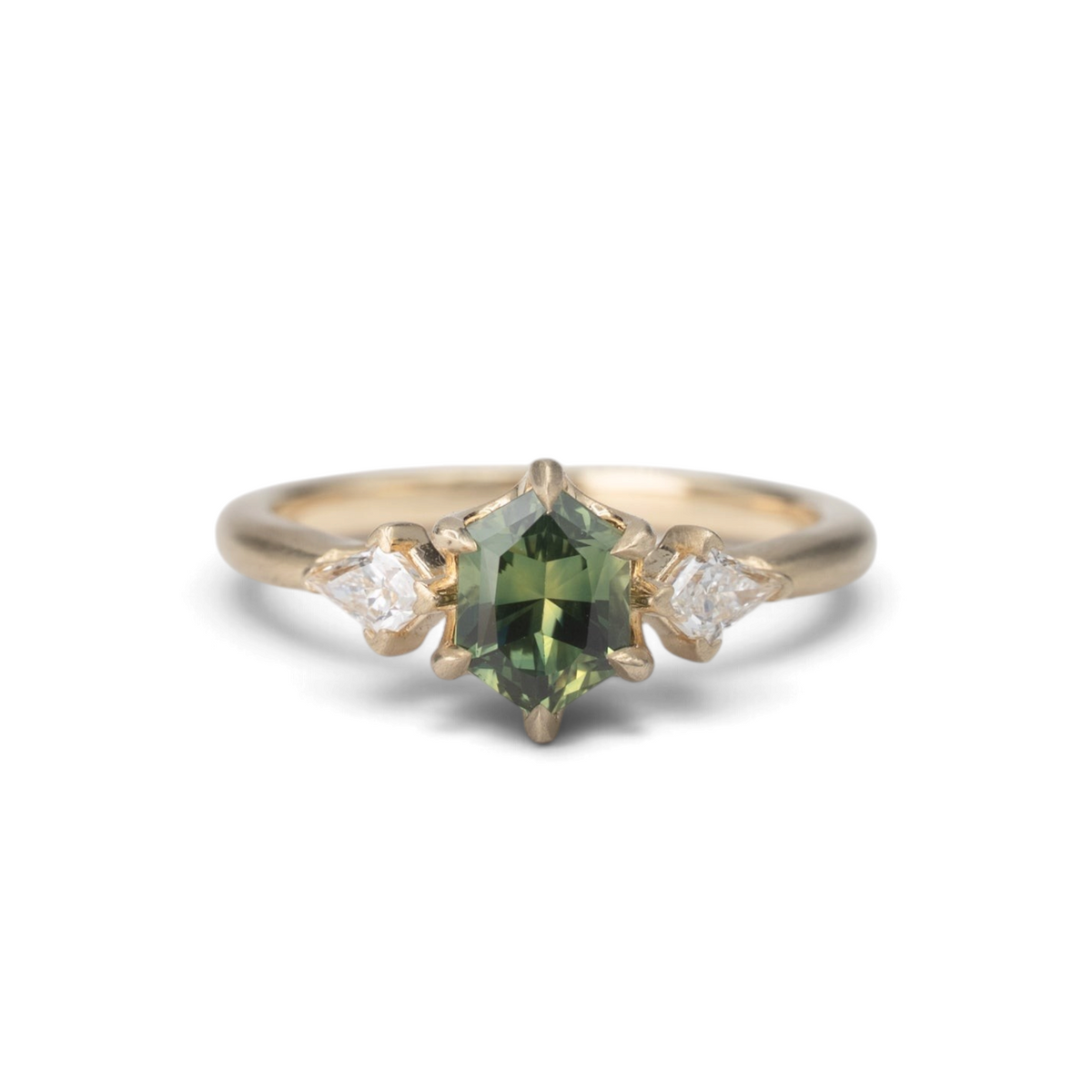 Stórica Studio 14k yellow gold ring featuring a 1.05ct elongated hexagon green sapphire and kite diamond accents.