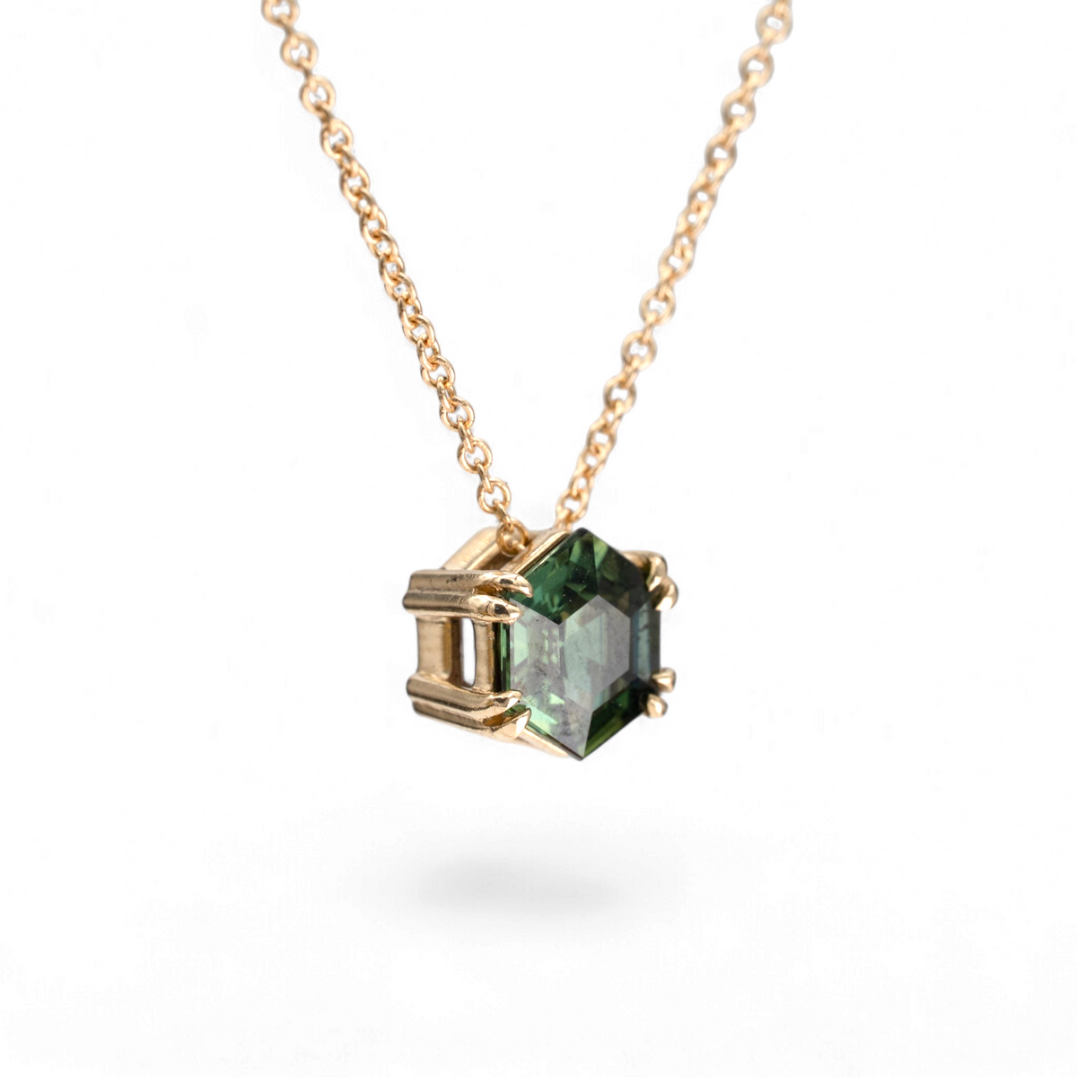 Stórica Studio 1.23ct hexagon step cut green sapphire slide necklace on an 18-inch gold cable chain.