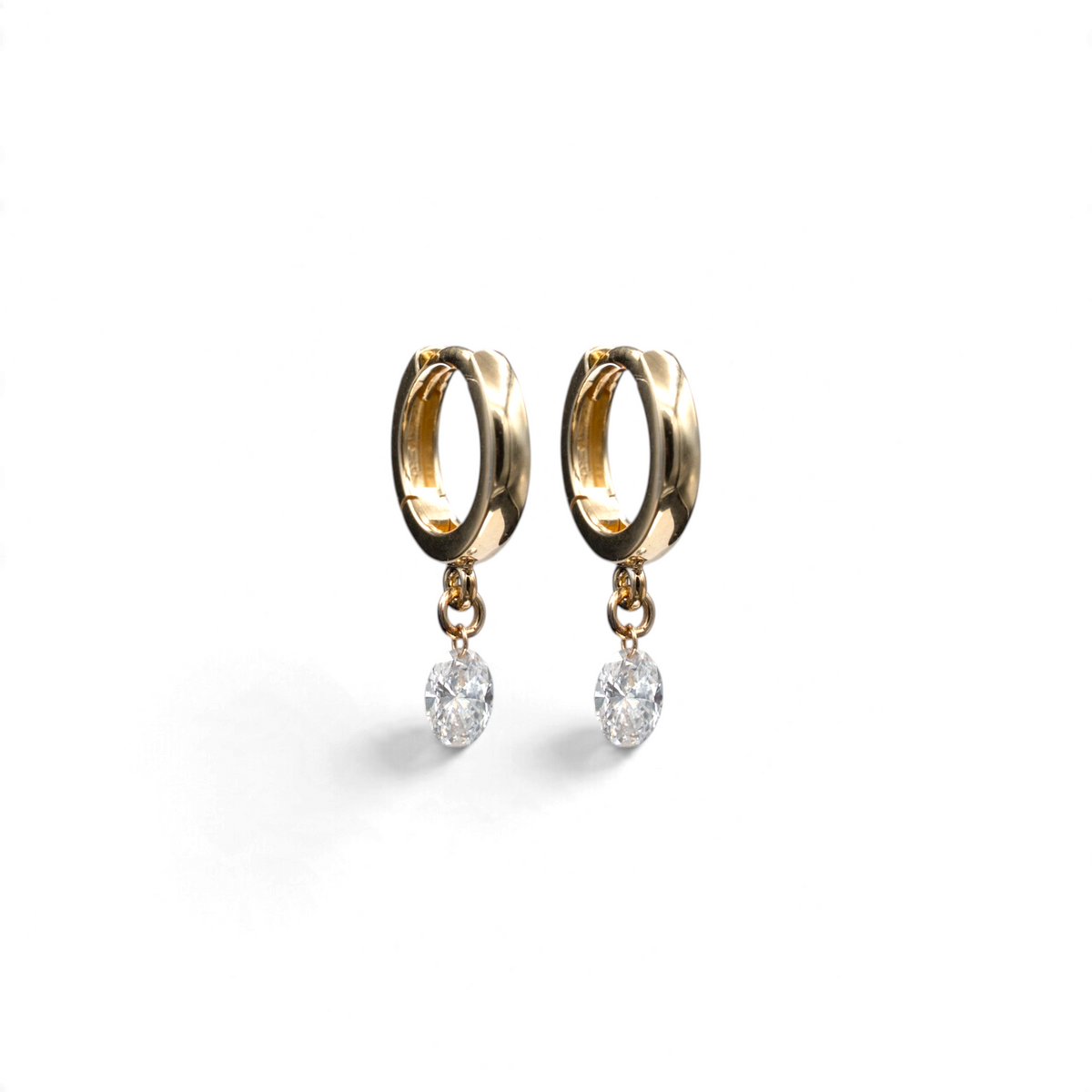 Stórica Studio Nereid drop huggie earrings featuring oval lab-grown diamonds suspended from 14k yellow gold hoops.