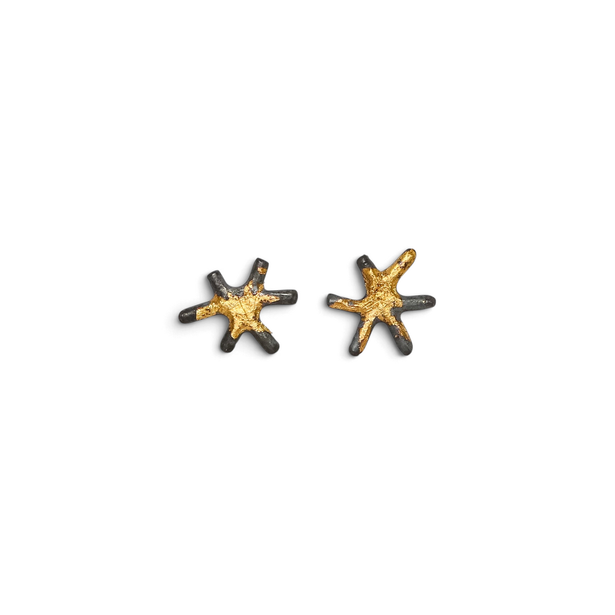 Stórica Studio Sol stud earrings featuring star-shaped oxidized sterling silver with 24k gold accents