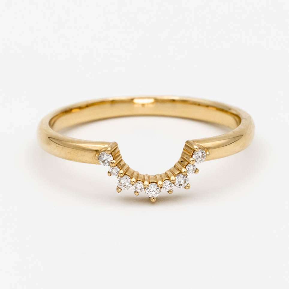 This beautiful, sparkling band features prong-set stones across a gentle curve that makes it perfectly stackable with most other rings. It would make a beautiful wedding or anniversary band, or a special treat for yourself.
