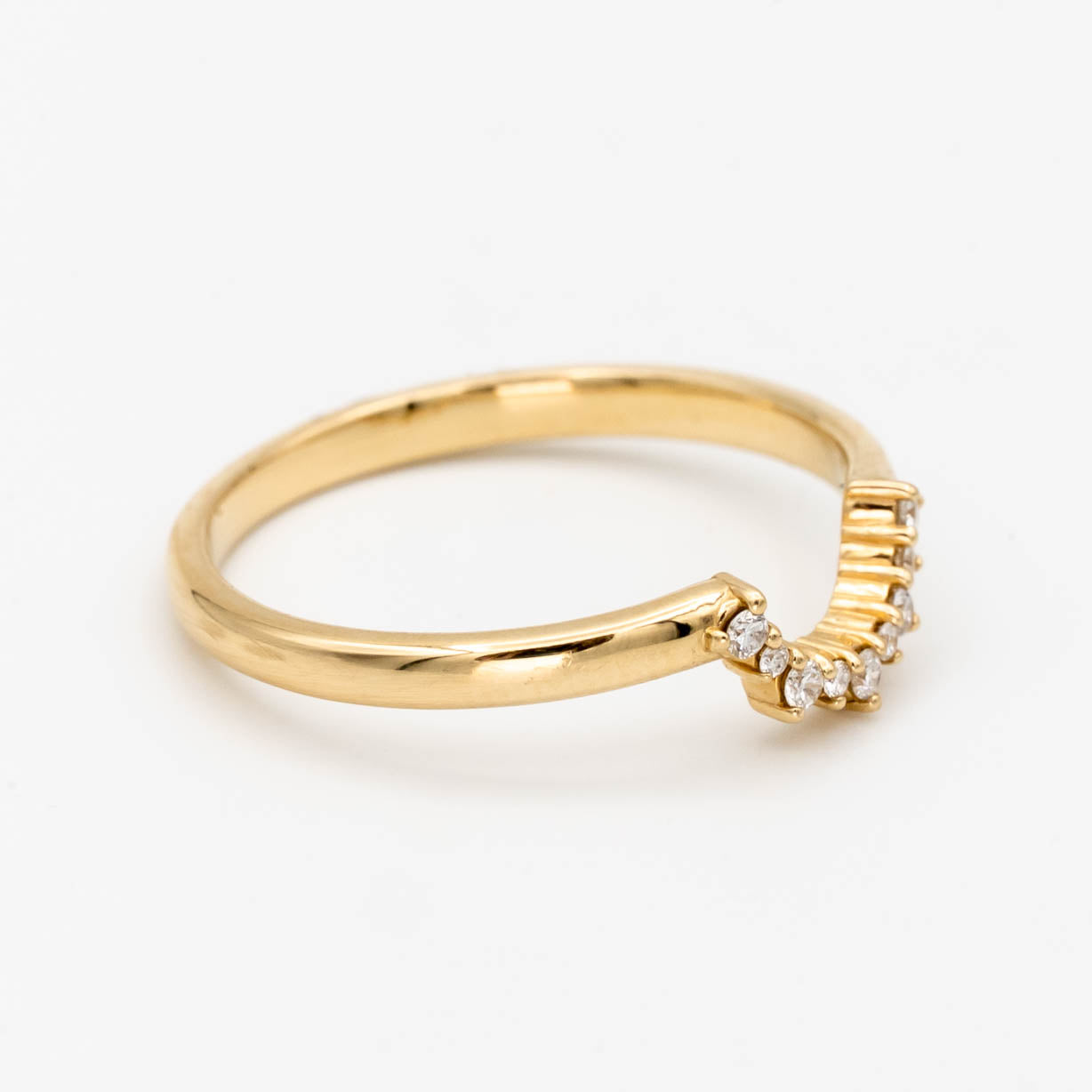 This beautiful, sparkling band features prong-set stones across a gentle curve that makes it perfectly stackable with most other rings. It would make a beautiful wedding or anniversary band, or a special treat for yourself.