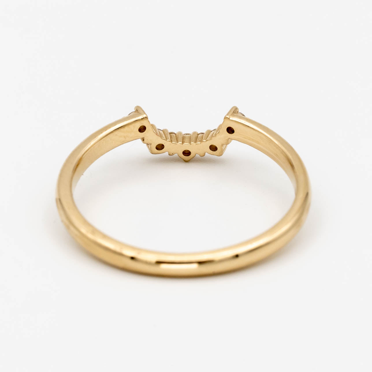 This beautiful, sparkling band features prong-set stones across a gentle curve that makes it perfectly stackable with most other rings. It would make a beautiful wedding or anniversary band, or a special treat for yourself.