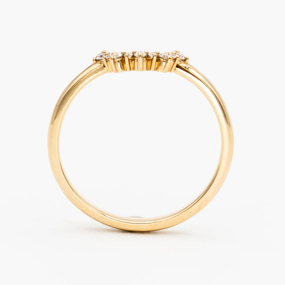 This beautiful, sparkling band features prong-set stones across a gentle curve that makes it perfectly stackable with most other rings. It would make a beautiful wedding or anniversary band, or a special treat for yourself.