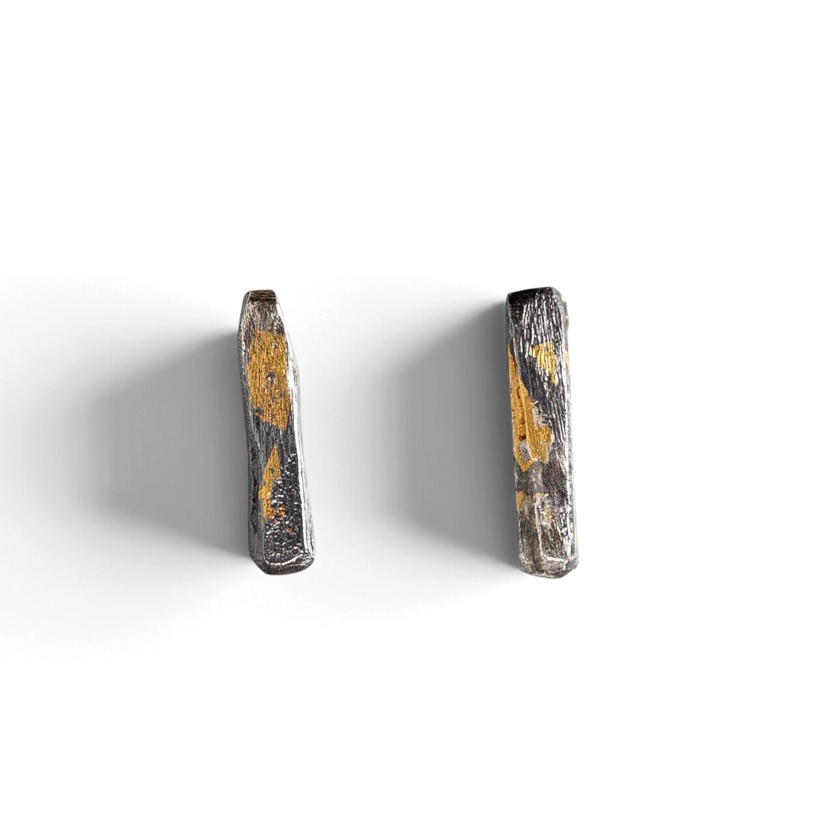 Stórica Studio Gilded Relic bar stud earrings in oxidized silver with 24k gold keum-boo foil accents.