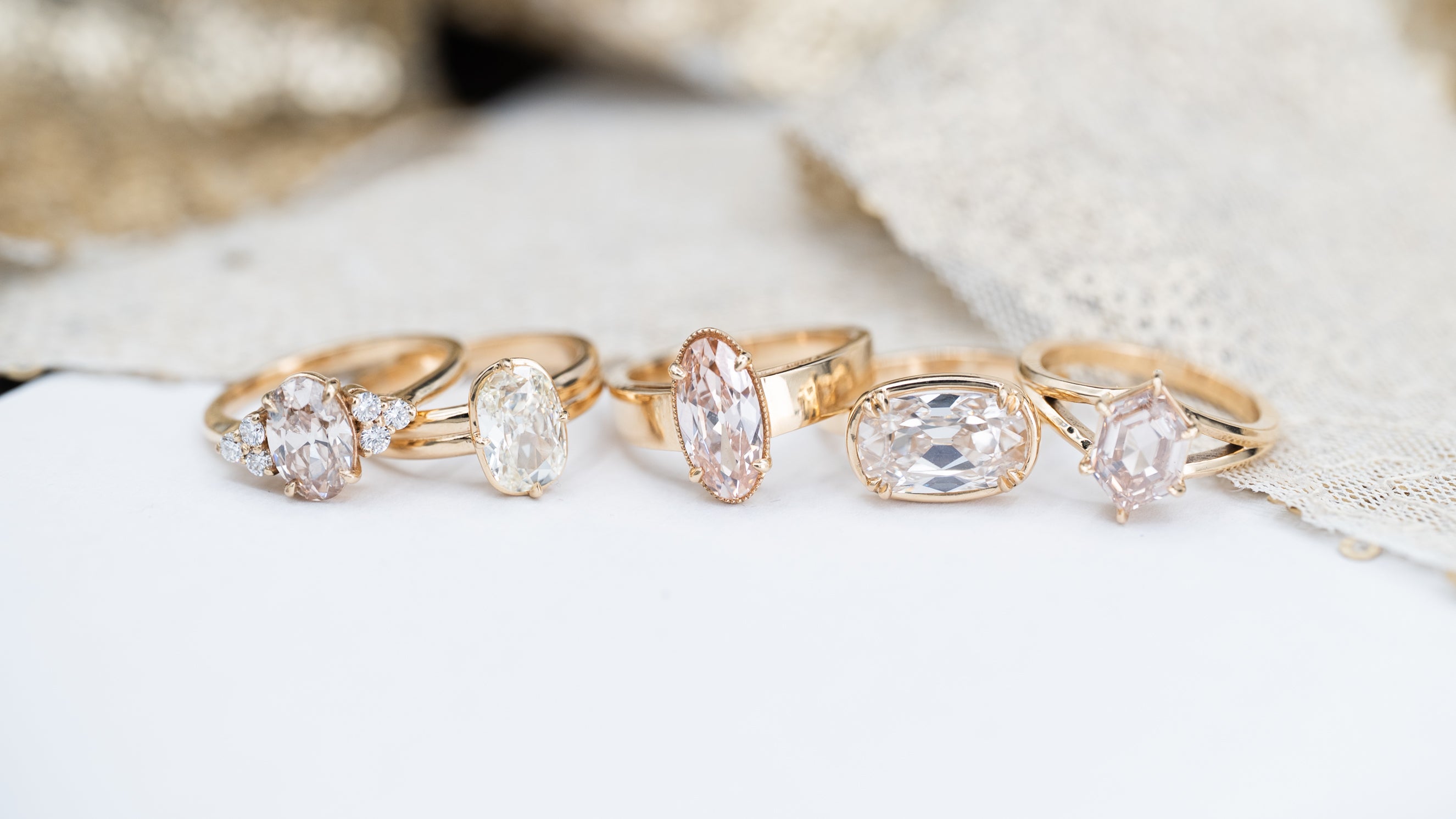 Set of gold rings with diamonds on a textured surface