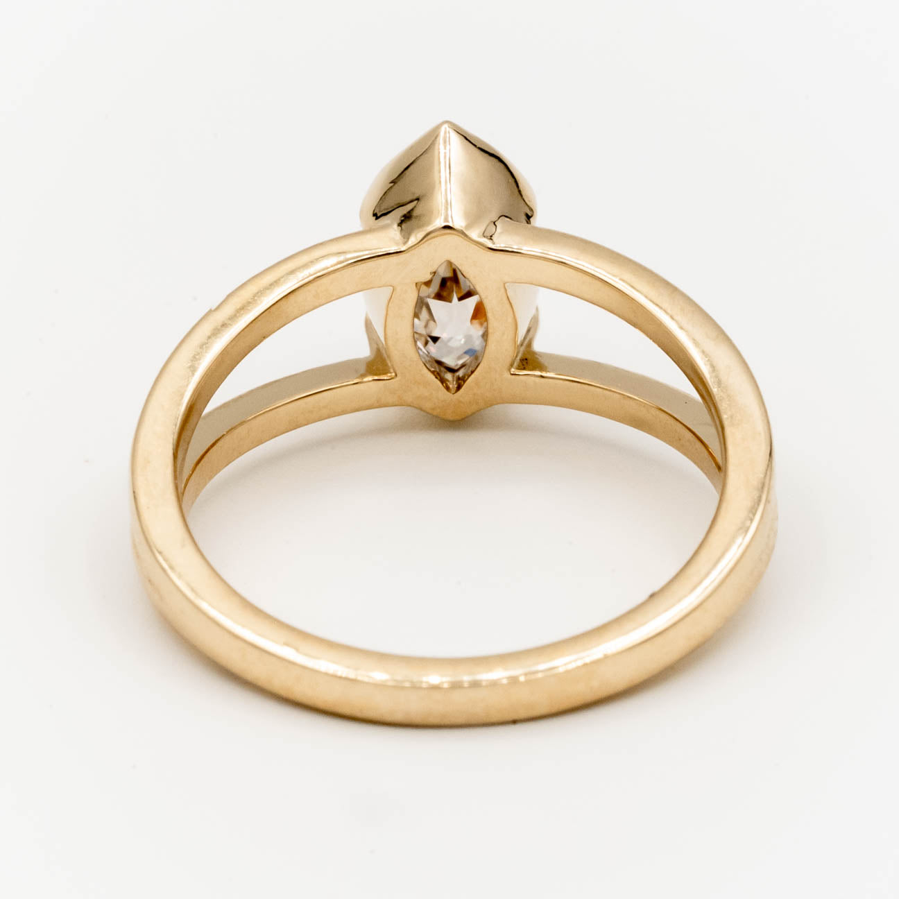 1.5ct Canadian-mined champagne diamond in a geometric marquise cut, set in a half-bezel Willow style double band, crafted in 14k yellow gold. Ethically sourced custom engagement ring from Seattle, WA.