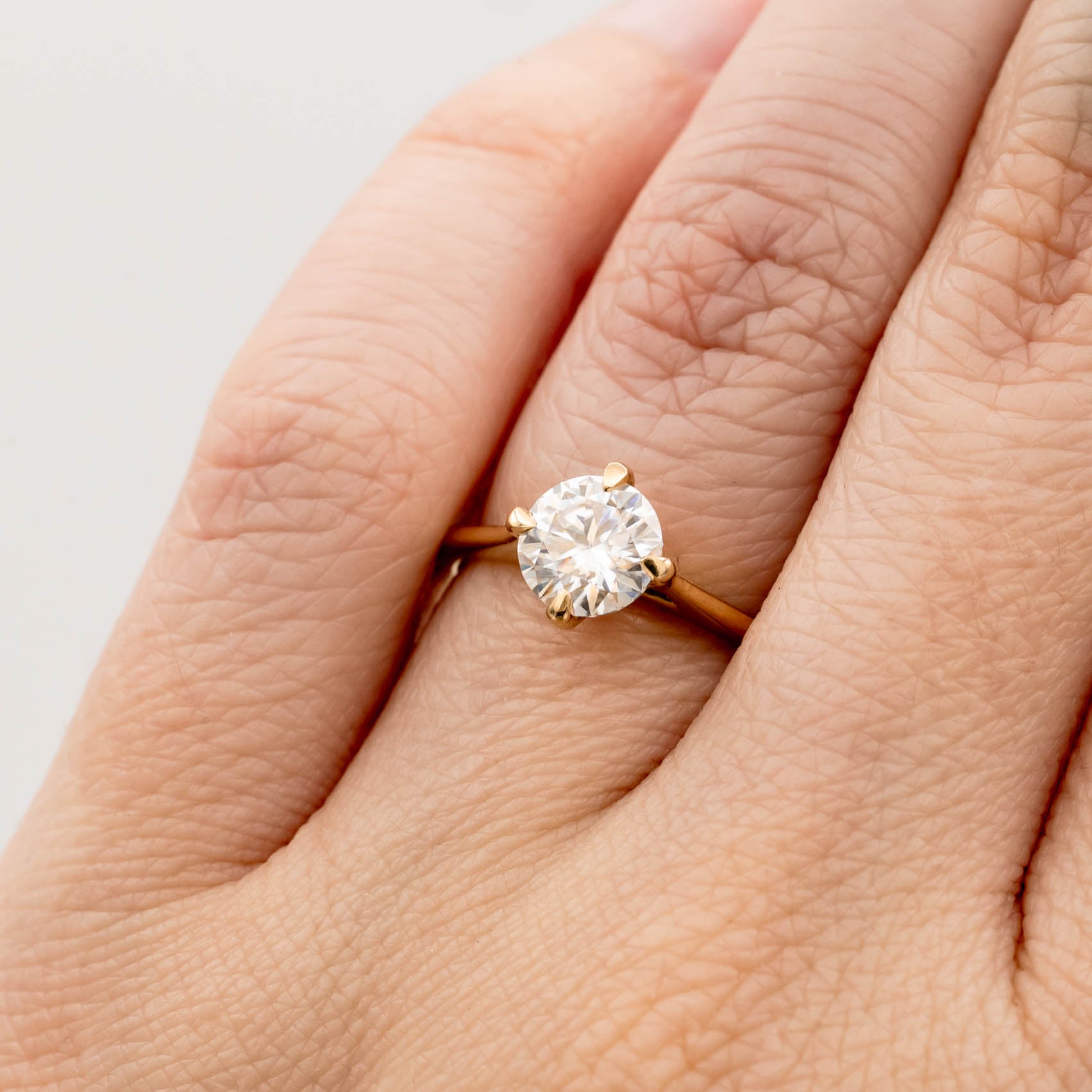 solitaire engagement ring, round-cut diamond ring, 14K yellow gold ring, classic diamond ring, minimalist engagement ring, prong setting ring, timeless jewelry, elegant proposal ring.