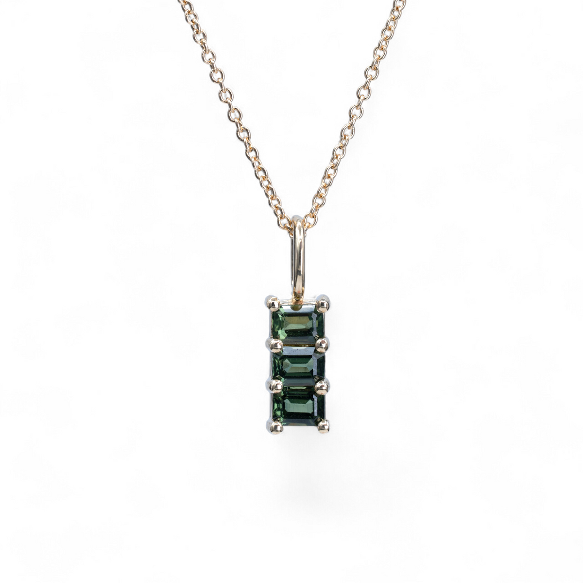 Fern green sapphire trio charm in 14k yellow gold on a fine cable chain