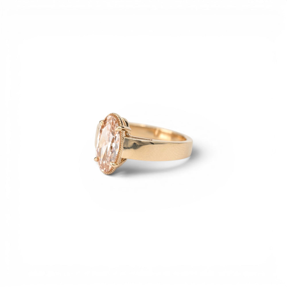 Stórica Studio custom engagement rings in Seattle, the Oak ring featuring a 1.8ct lab-grown champagne moval diamond with milgrain accent halo in a bold wide-band 14k yellow gold solitaire setting.