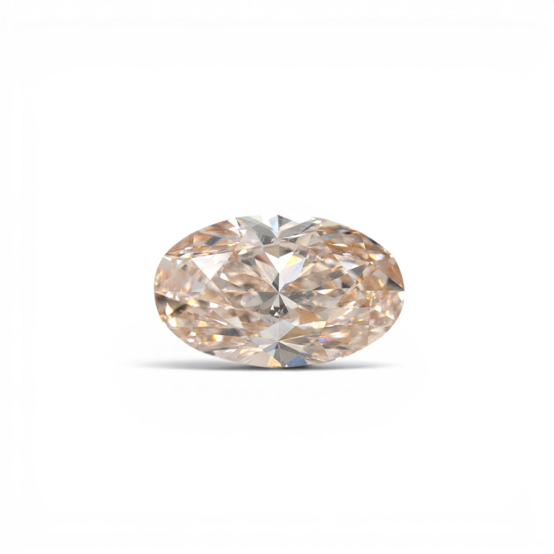 Stórica Studio custom engagement rings Seattle, 3.28ct oval brilliant lab-grown diamond in champagne C3, VVS2 clarity, with warm peach-golden tones, photographed loose on a white background.