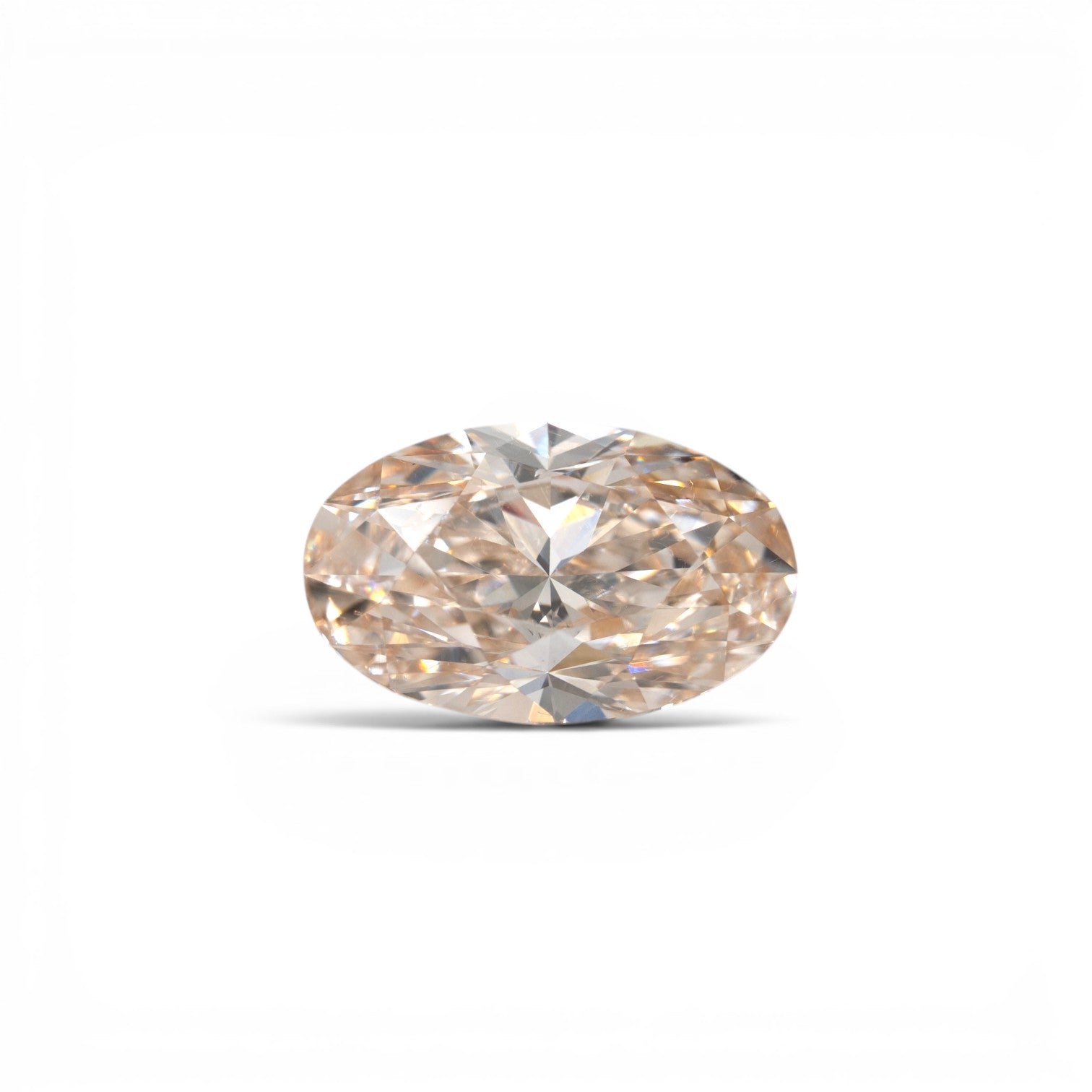 Stórica Studio custom engagement rings Seattle, 3.28ct oval brilliant lab-grown diamond in champagne C3, VVS2 clarity, with warm peach-golden tones, photographed loose on a white background.
