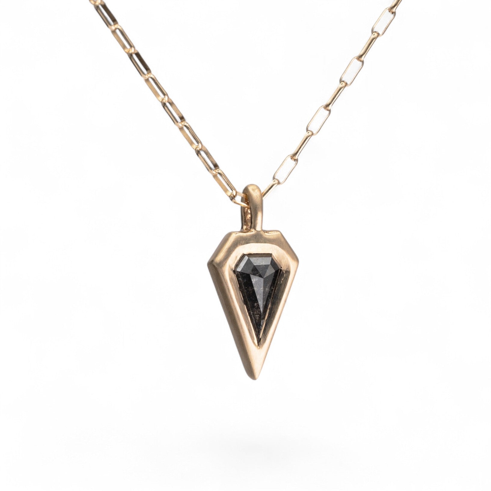 Stórica Studio Nyx pendant featuring a 0.91ct salt and pepper kite diamond in a 14K yellow gold bezel setting.