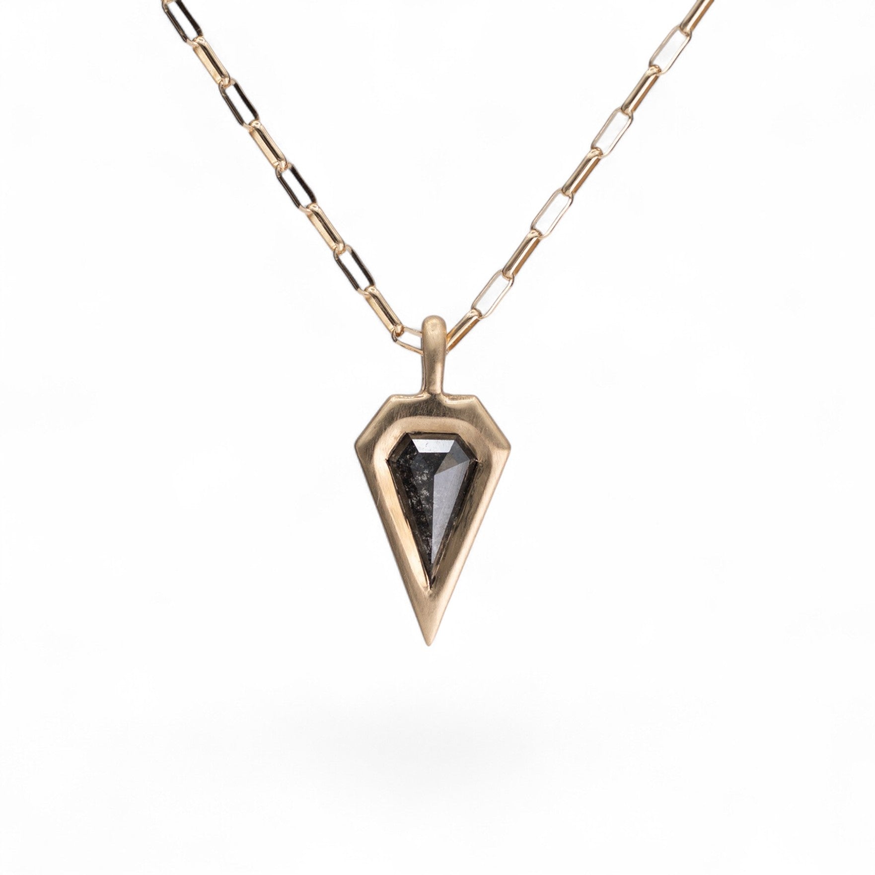 Stórica Studio Nyx pendant featuring a 0.91ct salt and pepper kite diamond in a 14K yellow gold bezel setting.