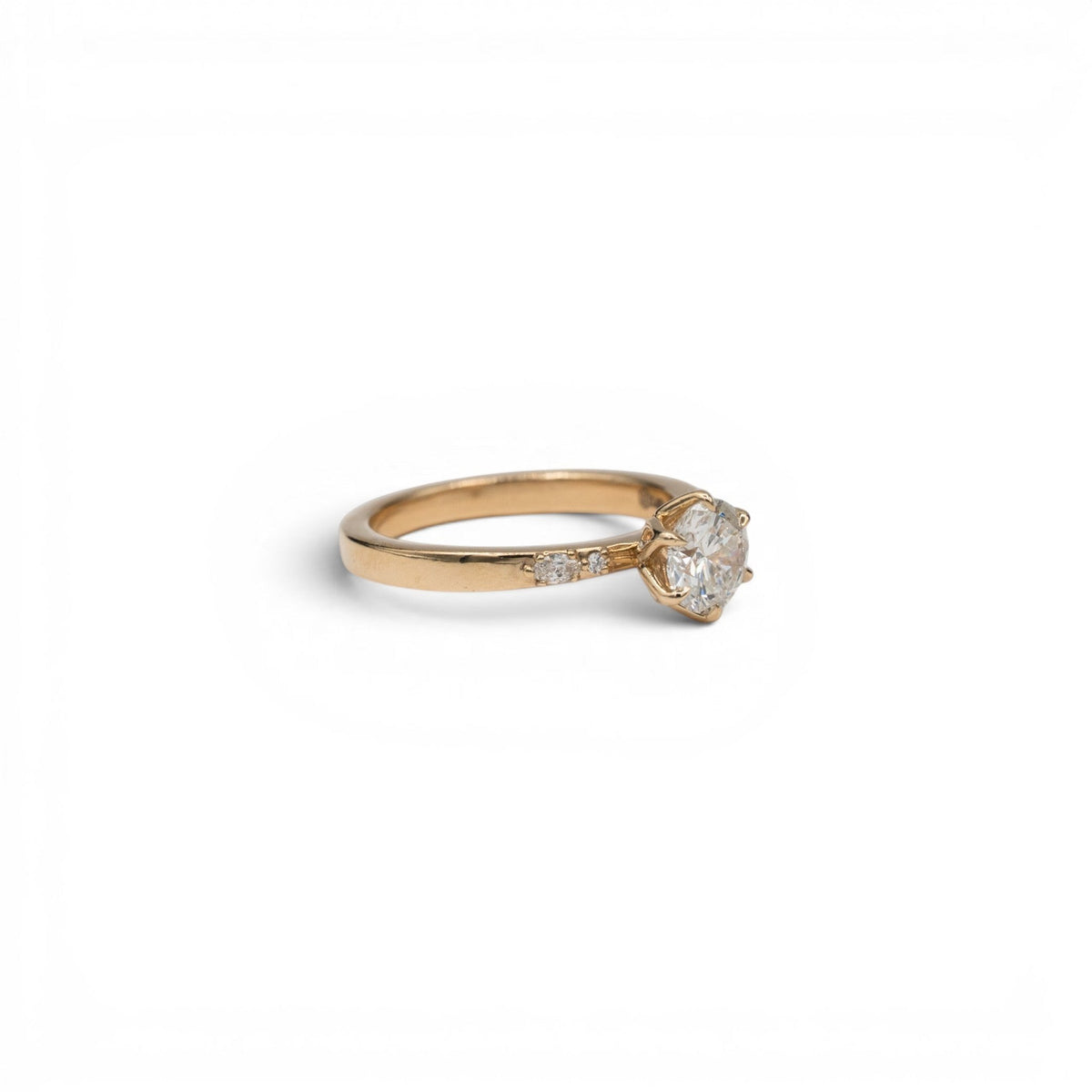 Stórica Studio Magnolia round diamond solitaire in 14k yellow gold with marquise diamond petal accents