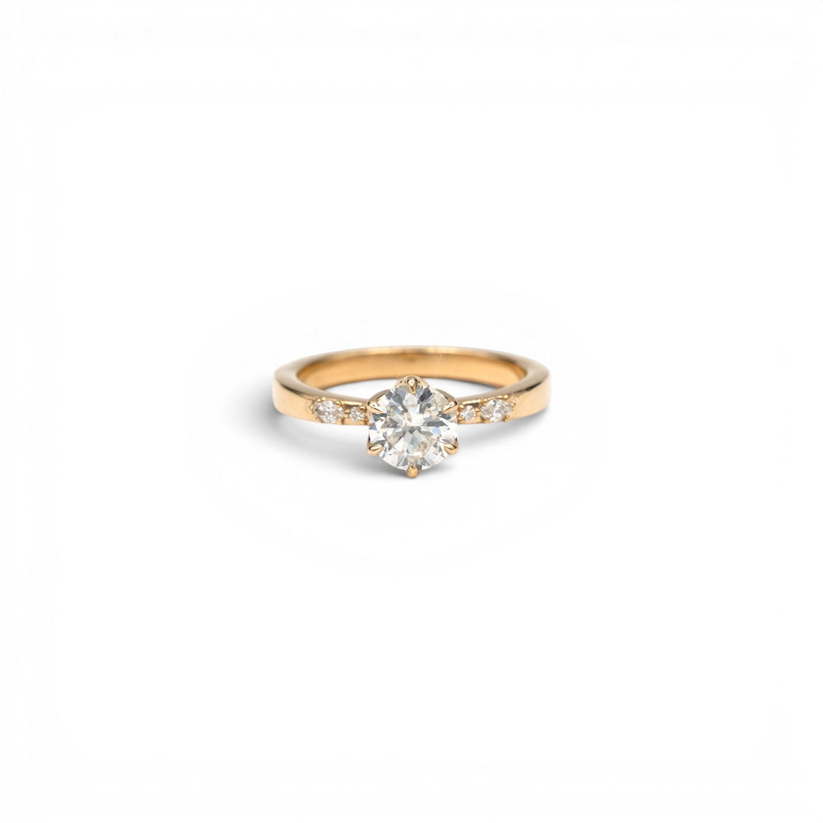 Stórica Studio Magnolia petal diamond solitaire ring in 14k yellow gold with a 0.91 ct round brilliant diamond in a tulip basket setting