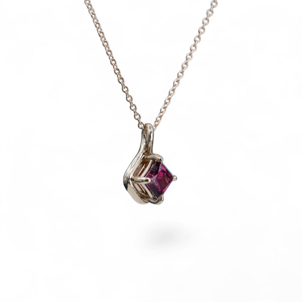 Dahlia raspberry spinel charm in 14k yellow gold, alternate view on a fine cable chain