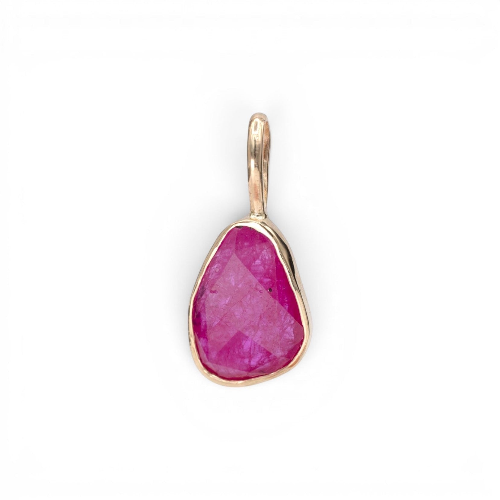 Stórica Studio freeform rose cut ruby pendant set in a 14k yellow gold bezel on a neutral background.