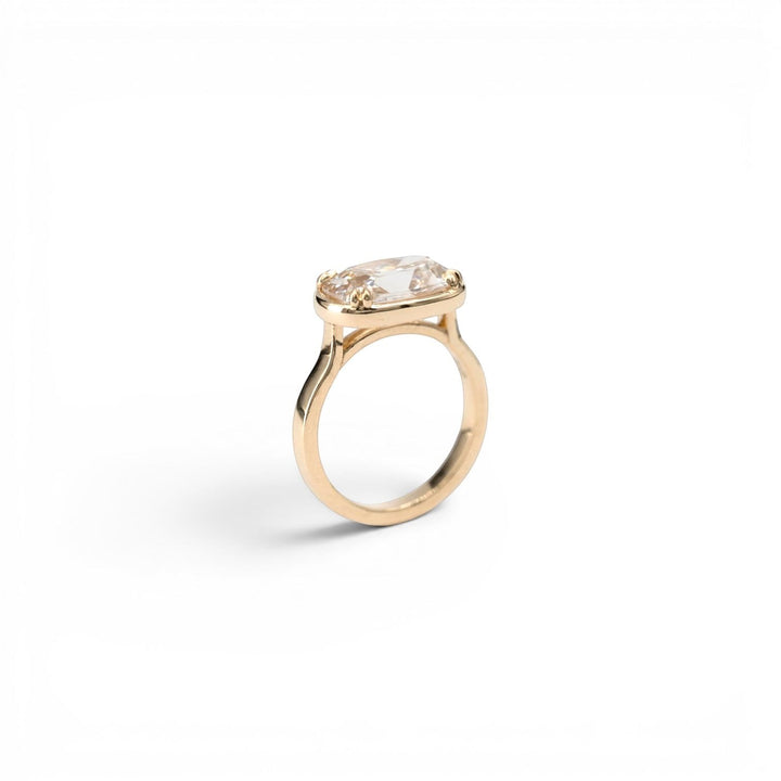 Stórica Studio The Cedar ring with a 3.5ct champagne antique cushion diamond in 14k yellow gold with double prongs and faux bezel.