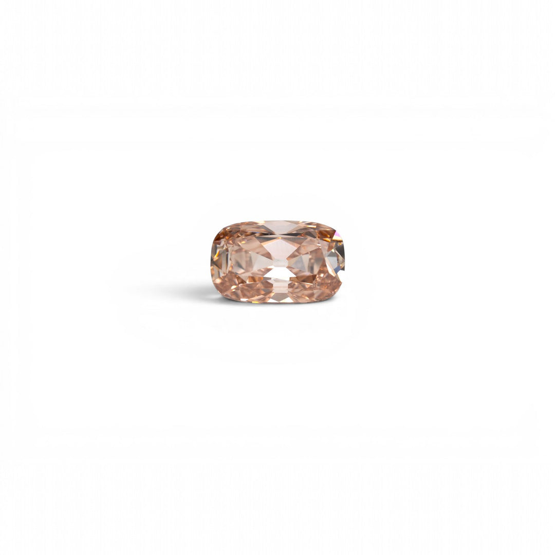 2.28ct elongated cushion old mine cut lab-grown diamond in champagne C3, VS1 clarity, with warm peachy-pink undertones, photographed loose on a light gray background. Storica Studio custom enegagement ring in Seattle.