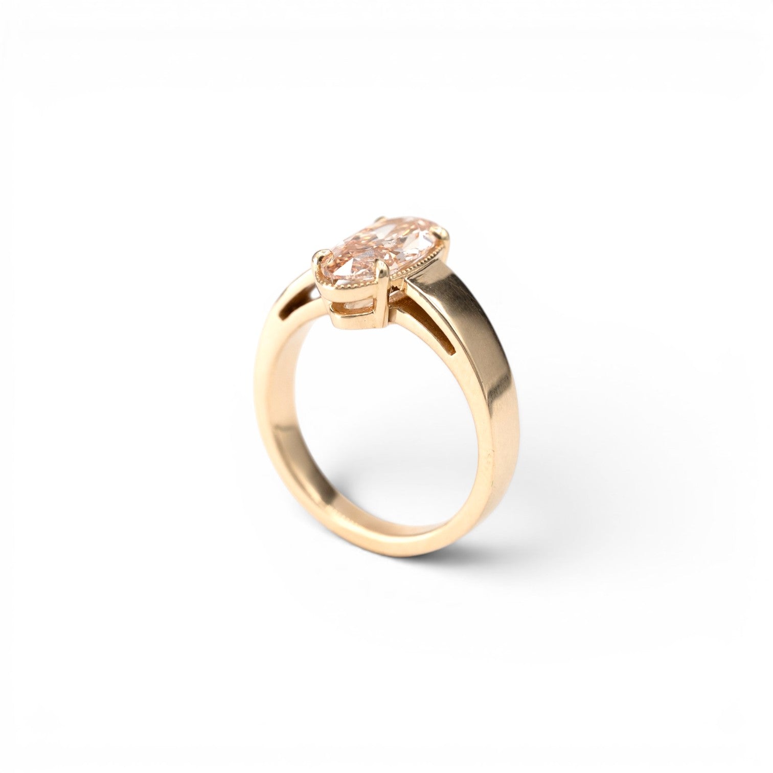 Stórica Studio custom engagement rings in Seattle, the Oak ring featuring a 1.8ct lab-grown champagne moval diamond with milgrain accent halo in a bold wide-band 14k yellow gold solitaire setting.