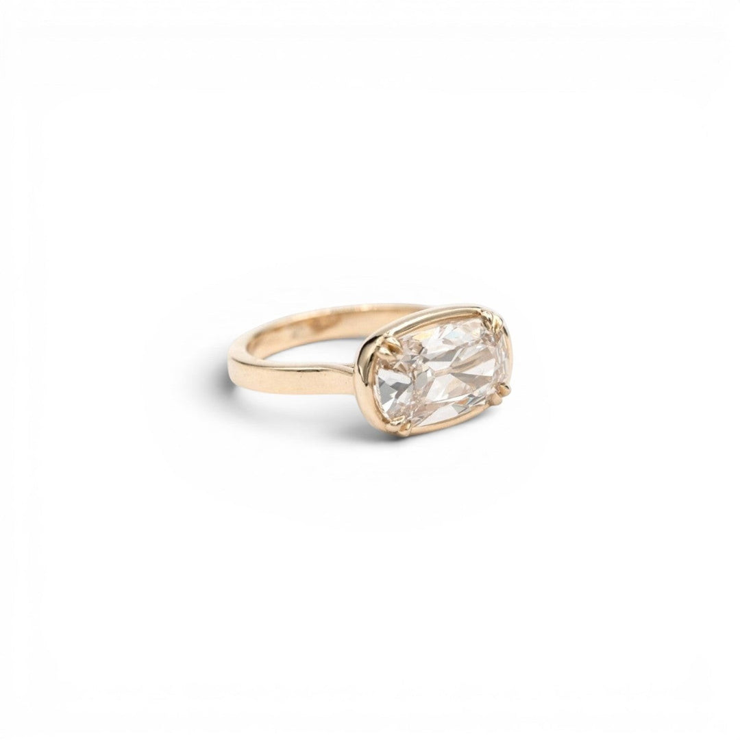 3.5ct lab-grown champagne antique-inspired cushion diamond in a double-prong faux bezel setting in 14k yellow gold, by Stórica Studio - custom engagement rings in Seattle.