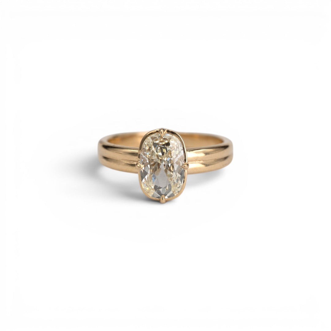 1.53ct earth-mined antique elongated cushion diamond in light yellow M color with compass prong setting in 14k yellow gold, by Stórica Studio - custom engagement rings in Seattle.