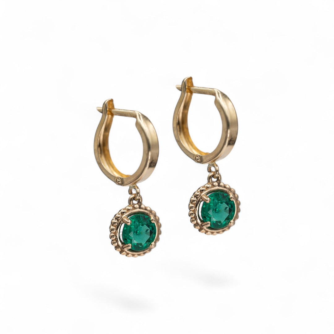 14k yellow gold hoop earrings with round natural emerald drop charms in beaded settings