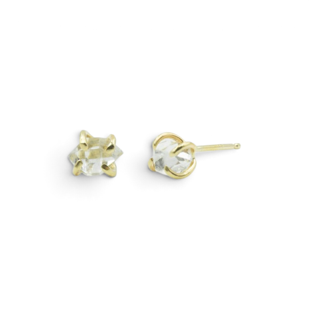Stórica Studio Herkimer diamond stud earrings featuring raw double-terminated quartz crystals set in 14k yellow gold.